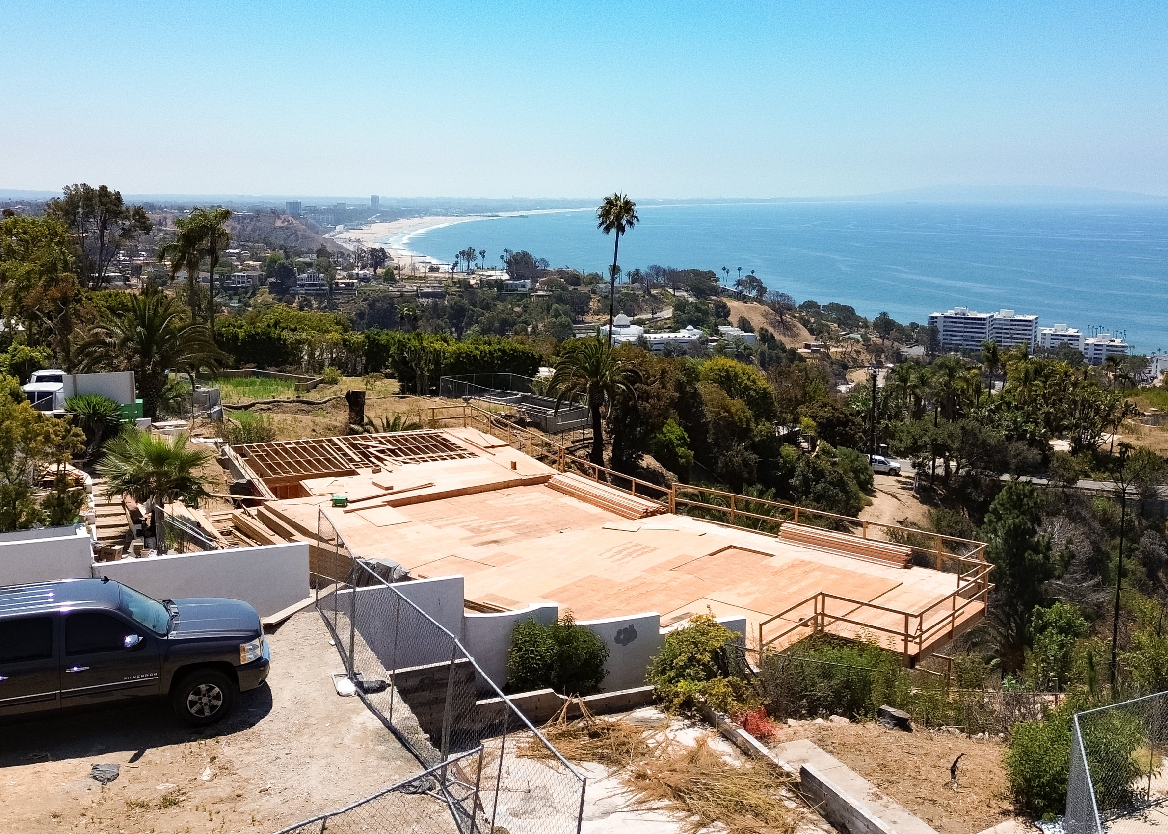 Coastal hills above the Pacific from the air, homes among the canyons