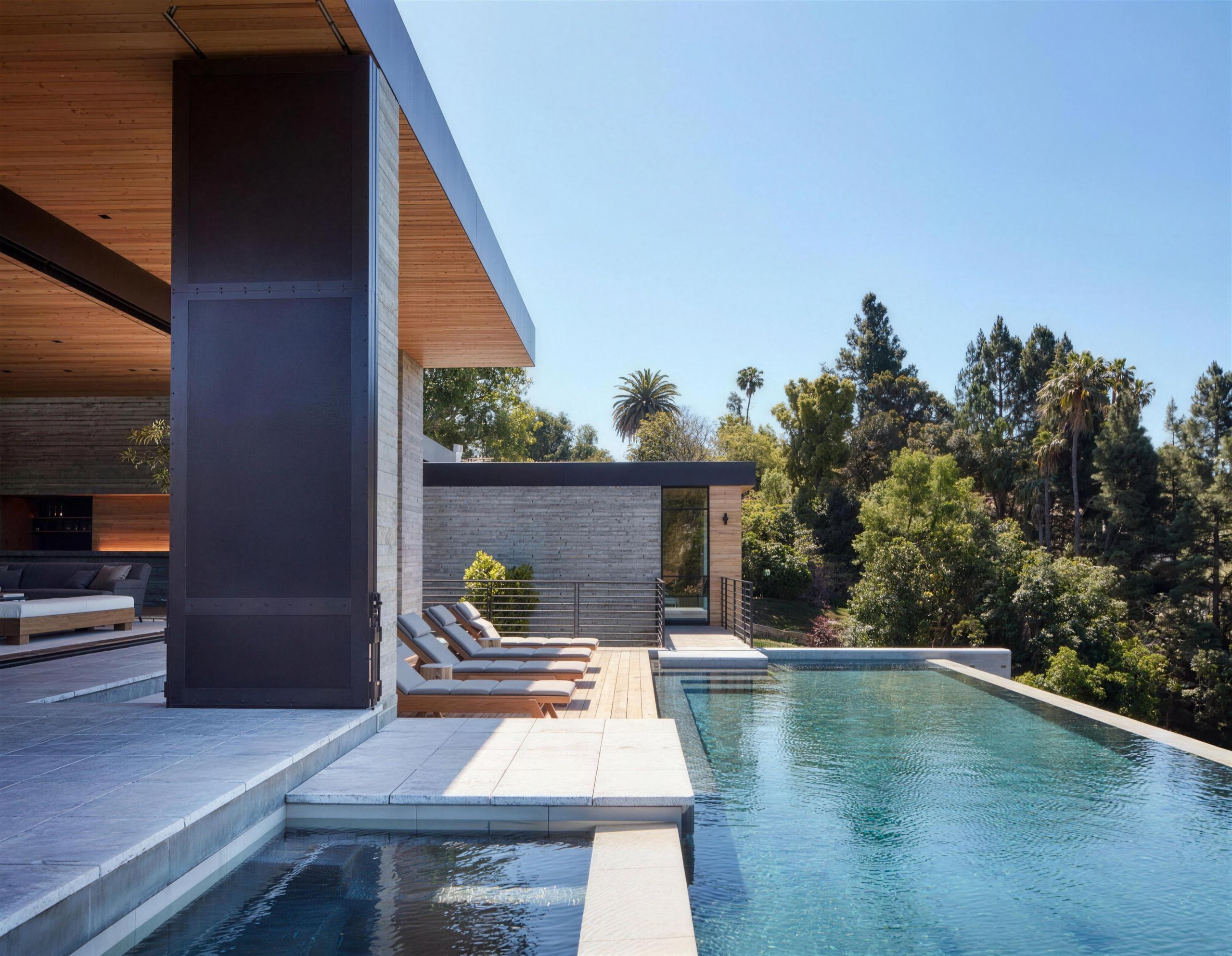 Infinity-edge pool and board-formed concrete residence above a wooded Los Angeles hillside