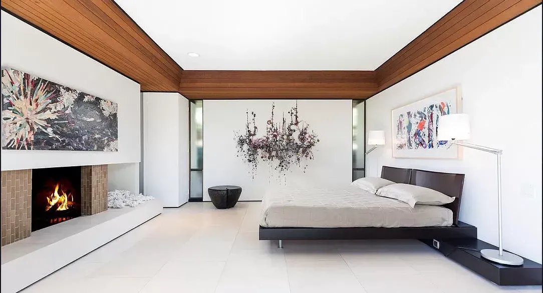 A Bel Air primary suite with a low bed and a wall of glass to the garden