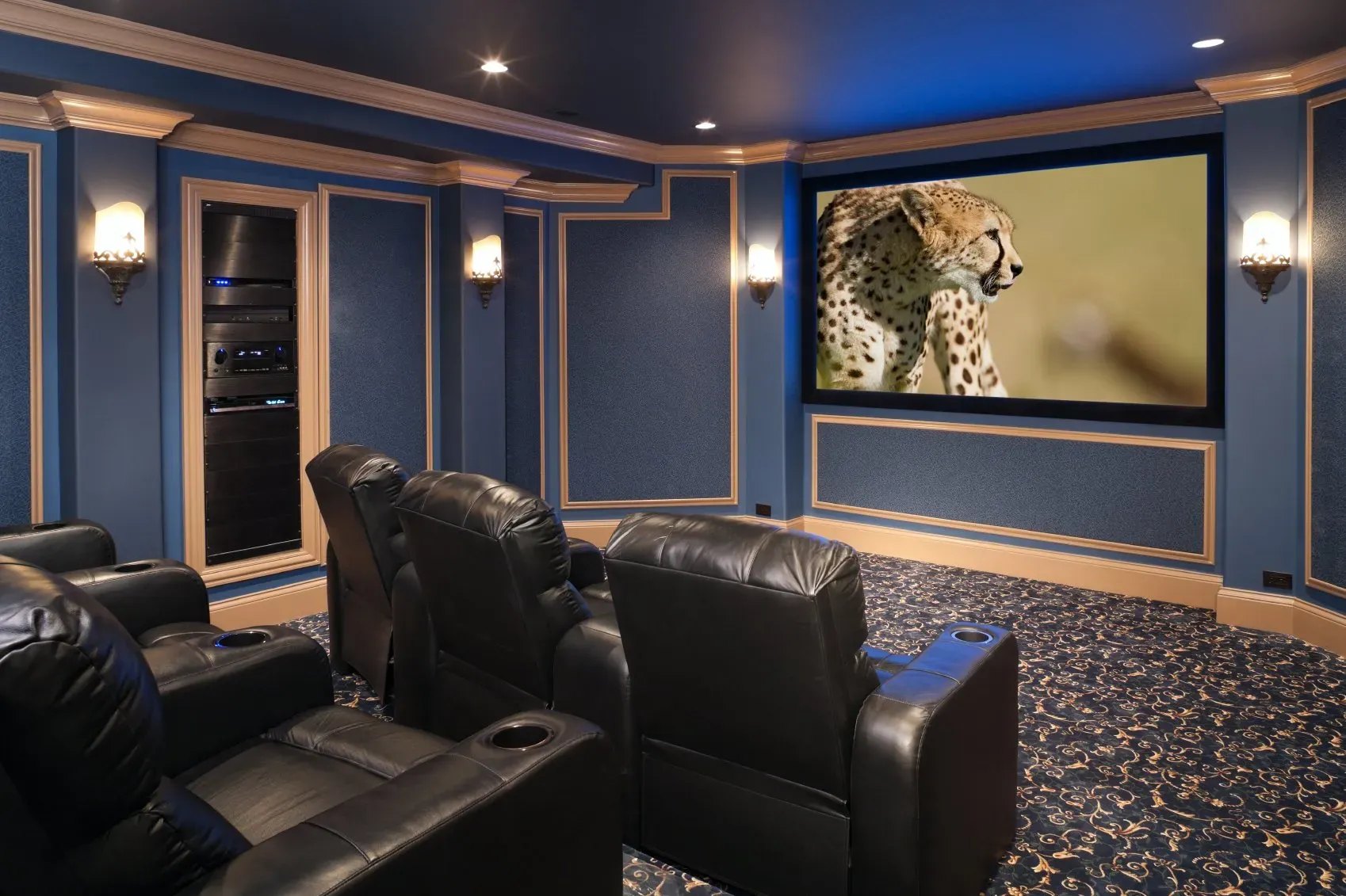 A Brentwood media room with tiered seating and a wide screen