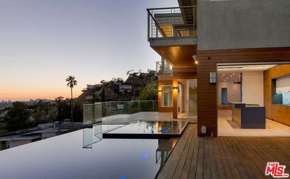 A pool and ipe deck carried over a Hollywood Hills slope, the basin beyond