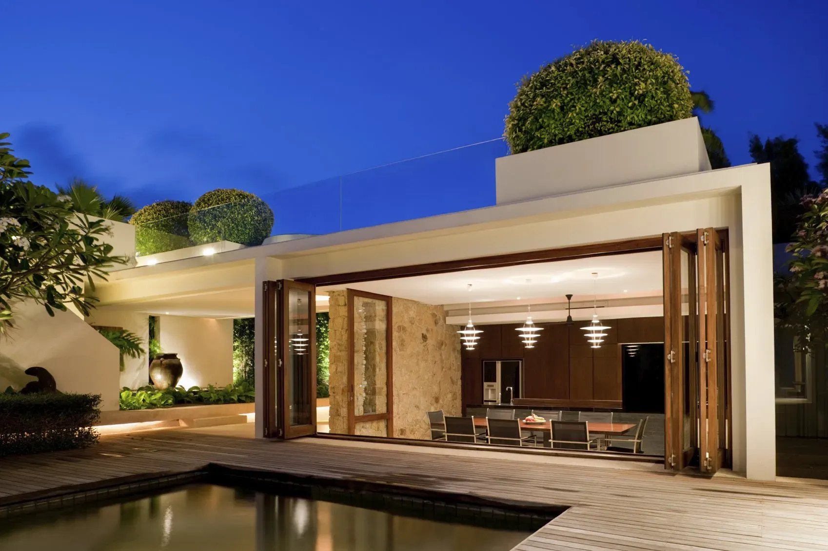 A pool house and outdoor living room by Addition Building and Design